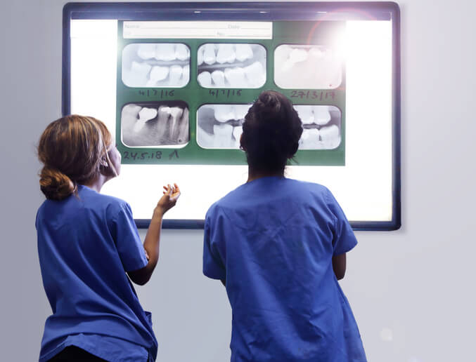 dentyści patrzący na zdjęcie rentgenowskie